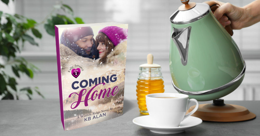 Paperback of Coming Home on counter next to teacup, honey and person pouring from electric kettle